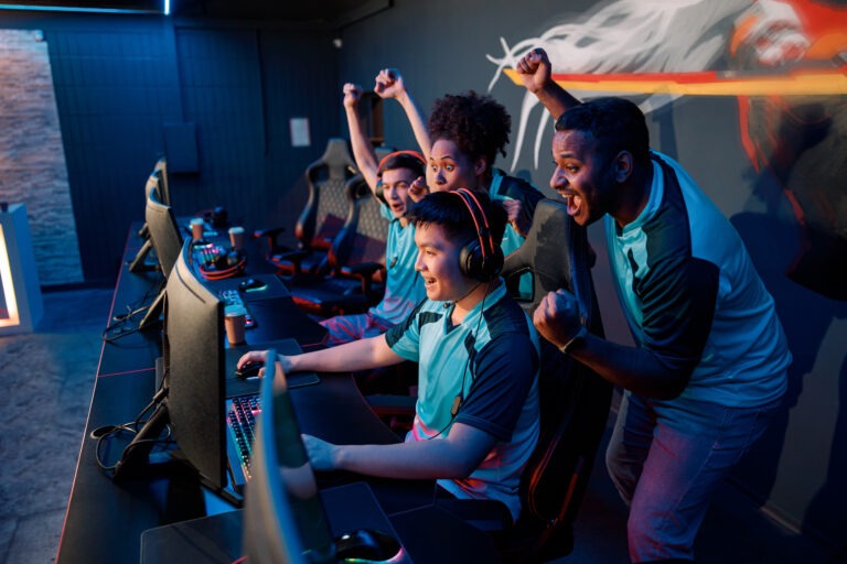 Young gamers playing online video game in cyber club